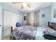 This bedroom is well-lit with a ceiling fan, window, closet and neutral-painted walls at 8140 Sw 109Th Street Rd, Ocala, FL 34481