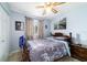 This bedroom is well-lit with a ceiling fan, window, and neutral-painted walls at 8140 Sw 109Th Street Rd, Ocala, FL 34481