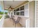 Inviting front porch features a ceiling fan and plenty of space for relaxing at 8140 Sw 109Th Street Rd, Ocala, FL 34481