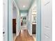 Hallway with hardwood floors leading to bedrooms and bathroom featuring updated fixtures and finishes at 8140 Sw 109Th Street Rd, Ocala, FL 34481