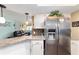Kitchen bar area with granite countertops and stainless steel refrigerator, open to the living room at 8140 Sw 109Th Street Rd, Ocala, FL 34481