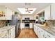 Traditional kitchen features stainless appliances, granite countertops, and bright recessed lighting at 8140 Sw 109Th Street Rd, Ocala, FL 34481