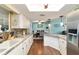 Bright kitchen with white cabinets and granite countertops views into living and dining spaces at 8140 Sw 109Th Street Rd, Ocala, FL 34481