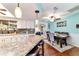 Eat-in kitchen with granite counters open to dining area and breakfast bar at 8140 Sw 109Th Street Rd, Ocala, FL 34481