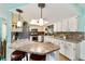 Well-lit kitchen with granite countertops, stainless steel appliances, and breakfast bar seating at 8140 Sw 109Th Street Rd, Ocala, FL 34481