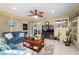 Bright sunroom with large windows, ceiling fan, comfortable seating, and modern entertainment setup at 8140 Sw 109Th Street Rd, Ocala, FL 34481