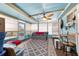 Sunroom with ample natural light, comfortable seating, and unique ceiling fan creating a relaxing atmosphere at 8140 Sw 109Th Street Rd, Ocala, FL 34481