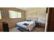 Simple bedroom with a bed, dresser, and natural light from the window at 8244 Sw 106Th Pl, Ocala, FL 34481