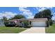 Charming home with a well-manicured lawn, attached two-car garage, and inviting covered porch at 8244 Sw 106Th Pl, Ocala, FL 34481