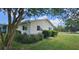 The side view of a well-maintained home featuring neat landscaping and lush green grass at 8244 Sw 106Th Pl, Ocala, FL 34481