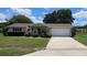 Attractive home with a front-entry garage, charming front porch, and mature landscaping at 8244 Sw 106Th Pl, Ocala, FL 34481