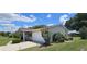 Exterior view of home with two car garage, manicured lawn, and mature landscaping at 8244 Sw 106Th Pl, Ocala, FL 34481