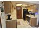 Well-lit kitchen featuring white appliances, tile floors, and light-colored cabinets at 8244 Sw 106Th Pl, Ocala, FL 34481