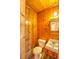 Rustic half-bathroom featuring wood paneling at 834 Ne 10Th Ave, Ocala, FL 34470