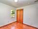 Bedroom with hardwood floors and a window and closet at 834 Ne 10Th Ave, Ocala, FL 34470