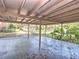 Spacious carport area with exposed roof and vegetation along the back fence at 834 Ne 10Th Ave, Ocala, FL 34470