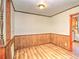 Cozy dining space with wood wainscoting, laminate floors, and an open doorway to the kitchen at 834 Ne 10Th Ave, Ocala, FL 34470