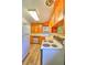 Efficient kitchen layout with traditional wood cabinets, tile countertops, and modern appliances at 834 Ne 10Th Ave, Ocala, FL 34470