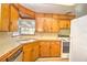 Functional kitchen featuring light wood cabinets, tile countertops, and modern appliances at 834 Ne 10Th Ave, Ocala, FL 34470