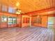 Expansive living area with wood-paneled walls, laminate flooring, and built in shelving at 834 Ne 10Th Ave, Ocala, FL 34470