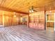 Large living room with wood-paneled walls, laminate flooring, and built in shelving at 834 Ne 10Th Ave, Ocala, FL 34470
