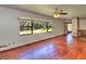 Spacious living room featuring hardwood floors, natural light, and a ceiling fan at 834 Ne 10Th Ave, Ocala, FL 34470