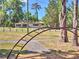 View of a ranch-style home and playground with monkey bars, showing the community's recreational facilities at 834 Ne 10Th Ave, Ocala, FL 34470