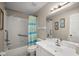 Bathroom with walk-in shower, grab bars, neutral walls, and updated vanity at 8617 Se 141St Street Rd, Summerfield, FL 34491