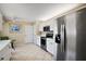 Bright kitchen features stainless steel appliances, white cabinetry, and neutral countertops at 8617 Se 141St Street Rd, Summerfield, FL 34491