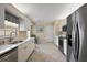 Functional kitchen with white cabinets, stainless steel appliances, and tiled flooring at 8617 Se 141St Street Rd, Summerfield, FL 34491
