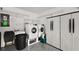 Functional laundry room with a washer, dryer, and storage cabinets at 8617 Se 141St Street Rd, Summerfield, FL 34491