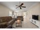 Large living room with comfortable seating, ceiling fan, and view to the kitchen at 8617 Se 141St Street Rd, Summerfield, FL 34491
