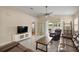 Bright living room with tile floors, leather furniture, and sliding glass doors to patio at 8617 Se 141St Street Rd, Summerfield, FL 34491