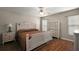 Spacious bedroom featuring a ceiling fan, white furniture, and a cozy quilt on the bed at 8617 Se 141St Street Rd, Summerfield, FL 34491