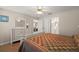 Bedroom features a white dresser, a bed with a quilt, and access to the bathroom at 8617 Se 141St Street Rd, Summerfield, FL 34491