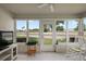 Inviting sunroom with tiled floors, lots of windows and natural light, and a view of the backyard at 8617 Se 141St Street Rd, Summerfield, FL 34491