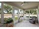 Bright sunroom with tiled floors, an abundance of windows, and relaxing seating at 8617 Se 141St Street Rd, Summerfield, FL 34491