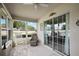 Well-lit sunroom offers tiled floors, large sliding glass doors, and comfortable seating at 8617 Se 141St Street Rd, Summerfield, FL 34491