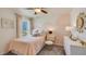 This lovely bedroom features lots of natural light, a ceiling fan, and cloud-themed accent paint at 8653 Sw 44Th Ter, Ocala, FL 34476