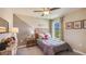 This bedroom features a ceiling fan, a large window, accent paint, and dinosaur-themed décor at 8653 Sw 44Th Ter, Ocala, FL 34476