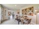 This dining room features modern decor, a view into the living area, and seating for six at 8653 Sw 44Th Ter, Ocala, FL 34476