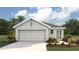 Charming single-Gathering home featuring a neutral color scheme, two-car garage, and landscaping at 8653 Sw 44Th Ter, Ocala, FL 34476