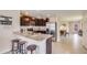 This modern kitchen features stainless steel appliances, a granite countertop, and a breakfast bar at 8653 Sw 44Th Ter, Ocala, FL 34476