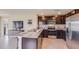 This modern kitchen features stainless steel appliances, dark cabinets, and a granite countertop at 8653 Sw 44Th Ter, Ocala, FL 34476