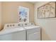 Bright laundry room with a window, showcasing a modern washer and dryer at 8653 Sw 44Th Ter, Ocala, FL 34476