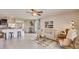 This living room features a ceiling fan, lots of natural light, and access to the kitchen at 8653 Sw 44Th Ter, Ocala, FL 34476