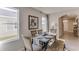 Bright dining room with natural light, wood table, and bench seating, perfect for Gathering meals at 8659 Sw 44Th Ter, Ocala, FL 34476