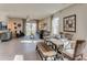Open living room features a dining area, comfortable seating, and sliding doors to the backyard at 8659 Sw 44Th Ter, Ocala, FL 34476