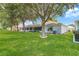 Manicured backyard with an expansive lawn and mature shade trees at 9287 Sw 91St Court Rd, Ocala, FL 34481