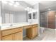 Bathroom vanity with double sinks, framed mirror, and tile floors at 9287 Sw 91St Court Rd, Ocala, FL 34481